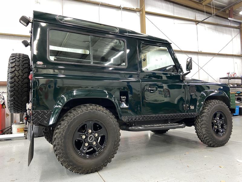 Green Land Rover Defender 90 in the shop