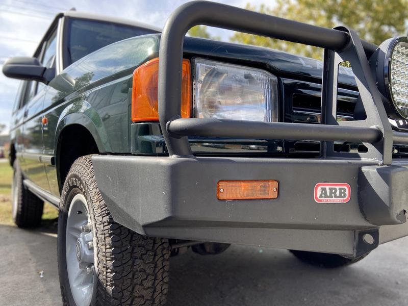 Front corner of green Land Rover Discovery 1 with ARB steel bumper