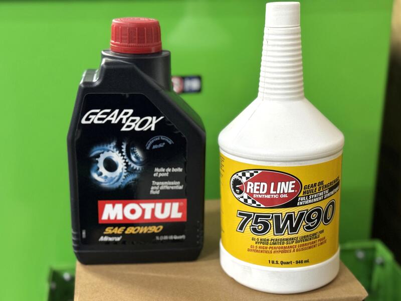 Two gear oil bottles from Redline and Motul for differentials and transfer cases