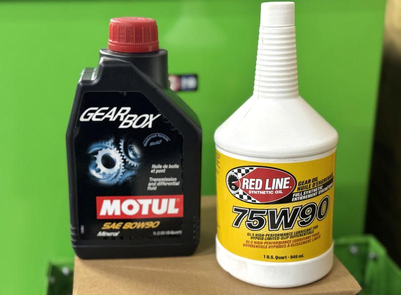 Two gear oil bottles from Redline and Motul for differentials and transfer cases