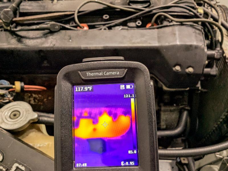 Underhood electrical compartment of Range Rover with oscilloscope amp clamp and multimeter