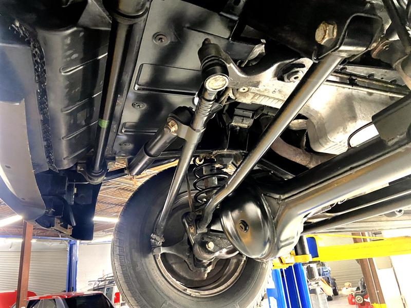 Underside of the front of a Land Rover Disovery II showing steering and suspension components