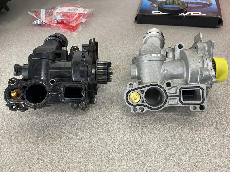 original VW/Audi plastic water pump next to upgraded aftermarket aluminum pump